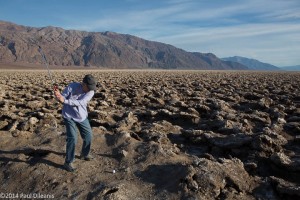 Patti takes a swing at the Devil's Golf Course. Death Valley NP